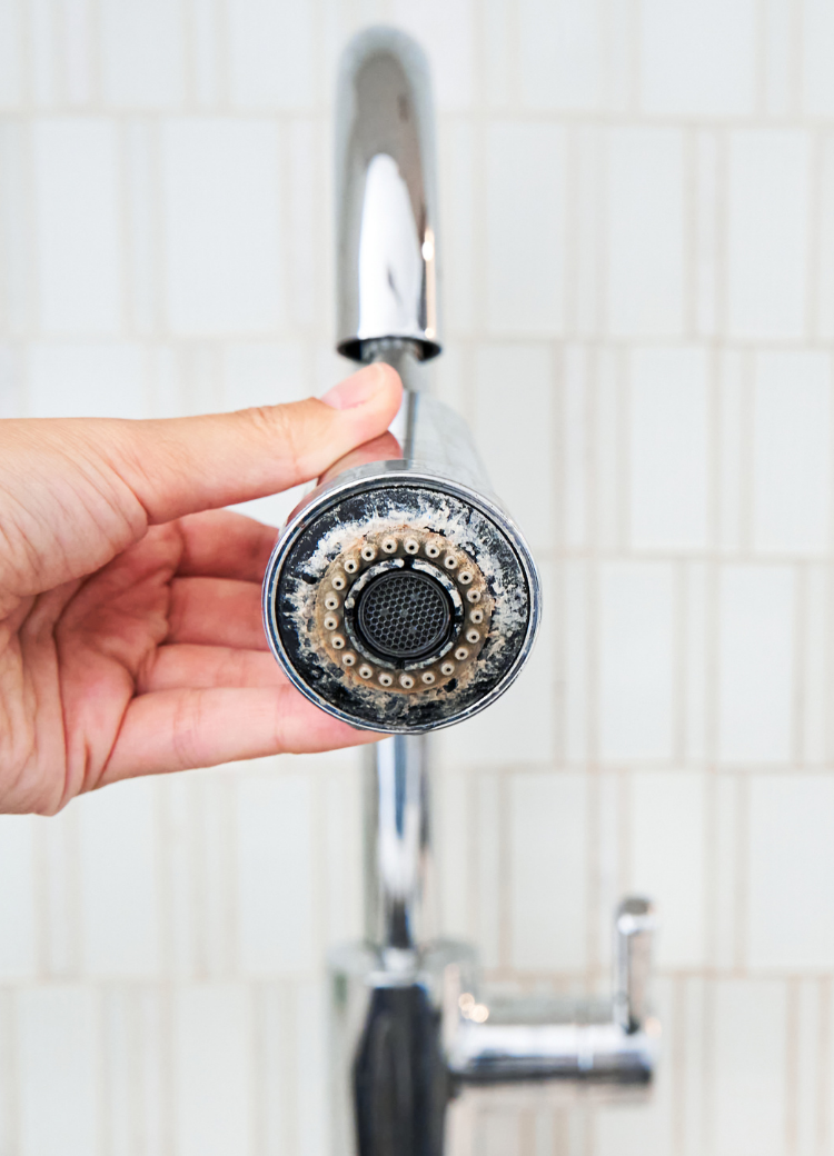 close up of a tap covered in limescale