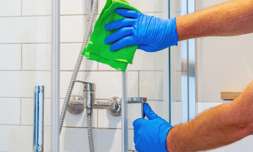 Removing hard water stains from a shower screen