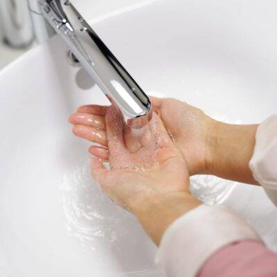 Person washing their hands implying the health effects of hard water